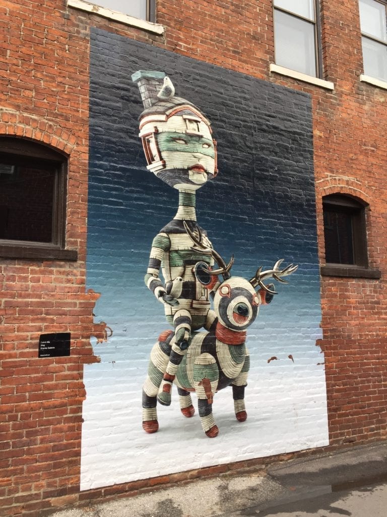 Painted wall mural of a robot on a deer