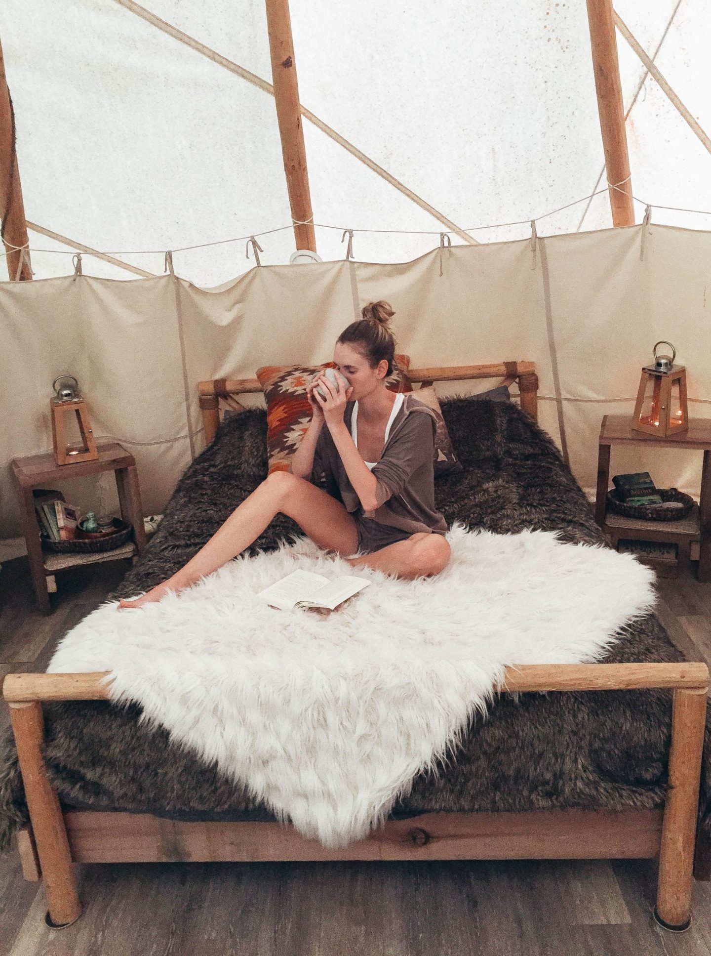 girl drinking on a bed 