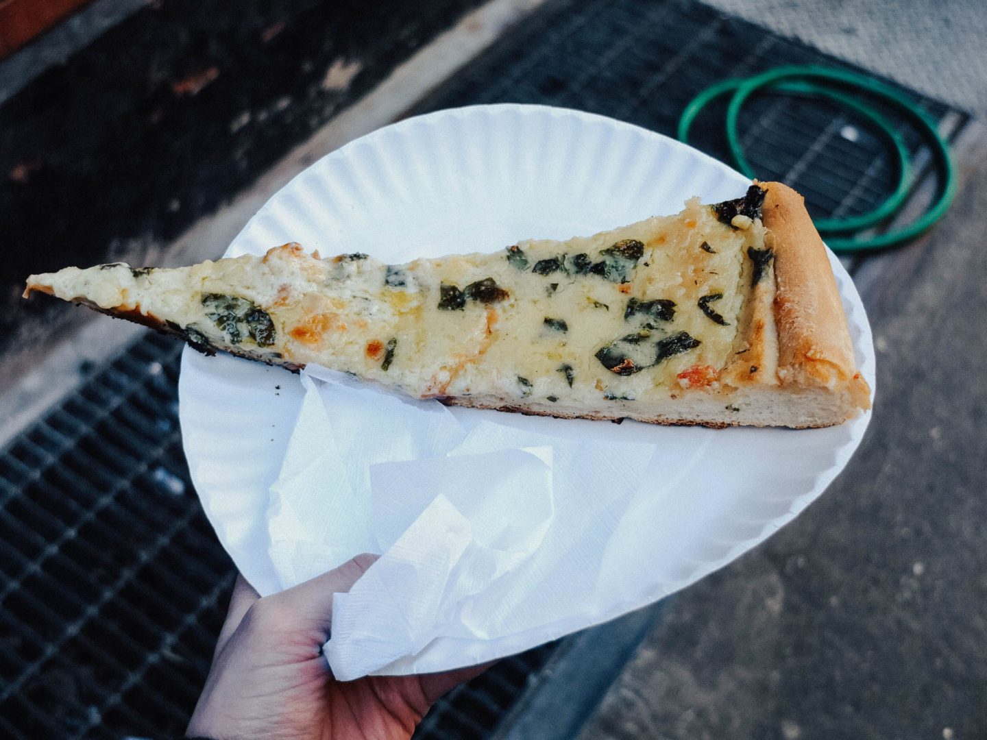 Large artichoke pizza slice on a plate