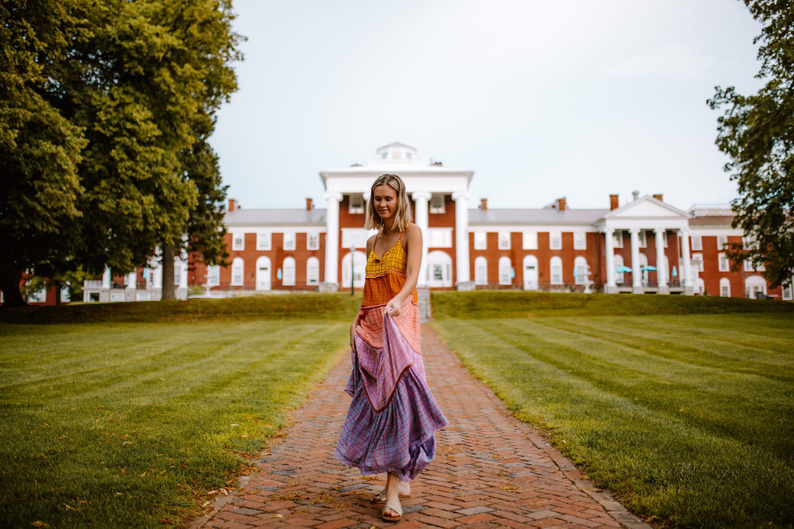 girl in colorful dress in front of Blackburn Inn hotel, weekend guide to Staunton Virginia