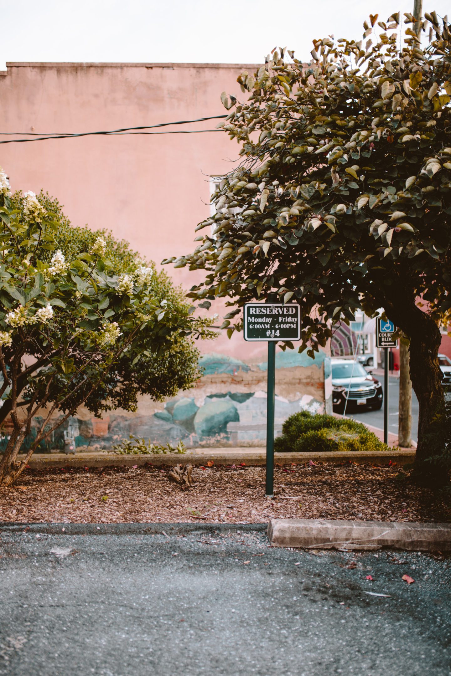car park with pink wall in background