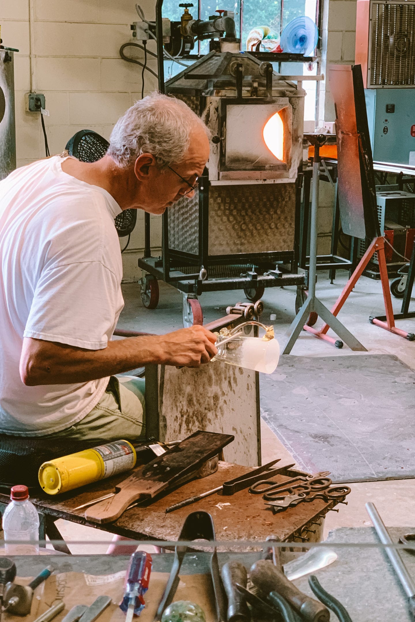 man doing a glass blowing demonstration