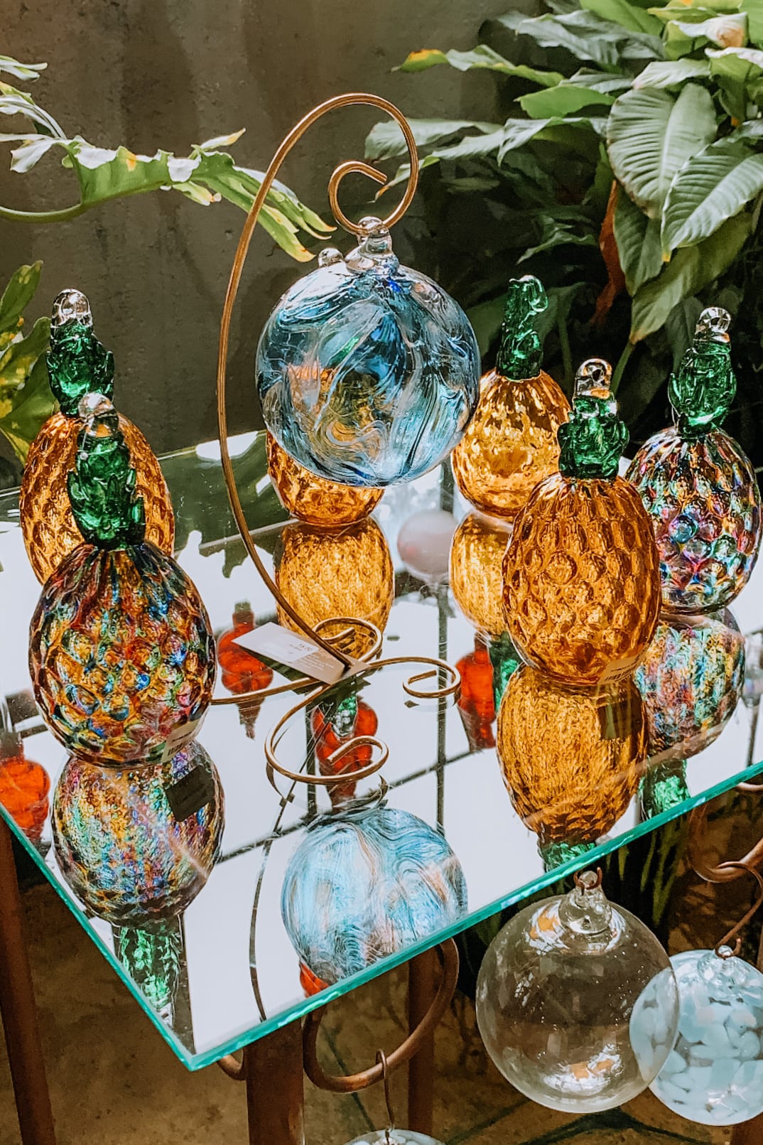 glass decor pineapples on display shelf
