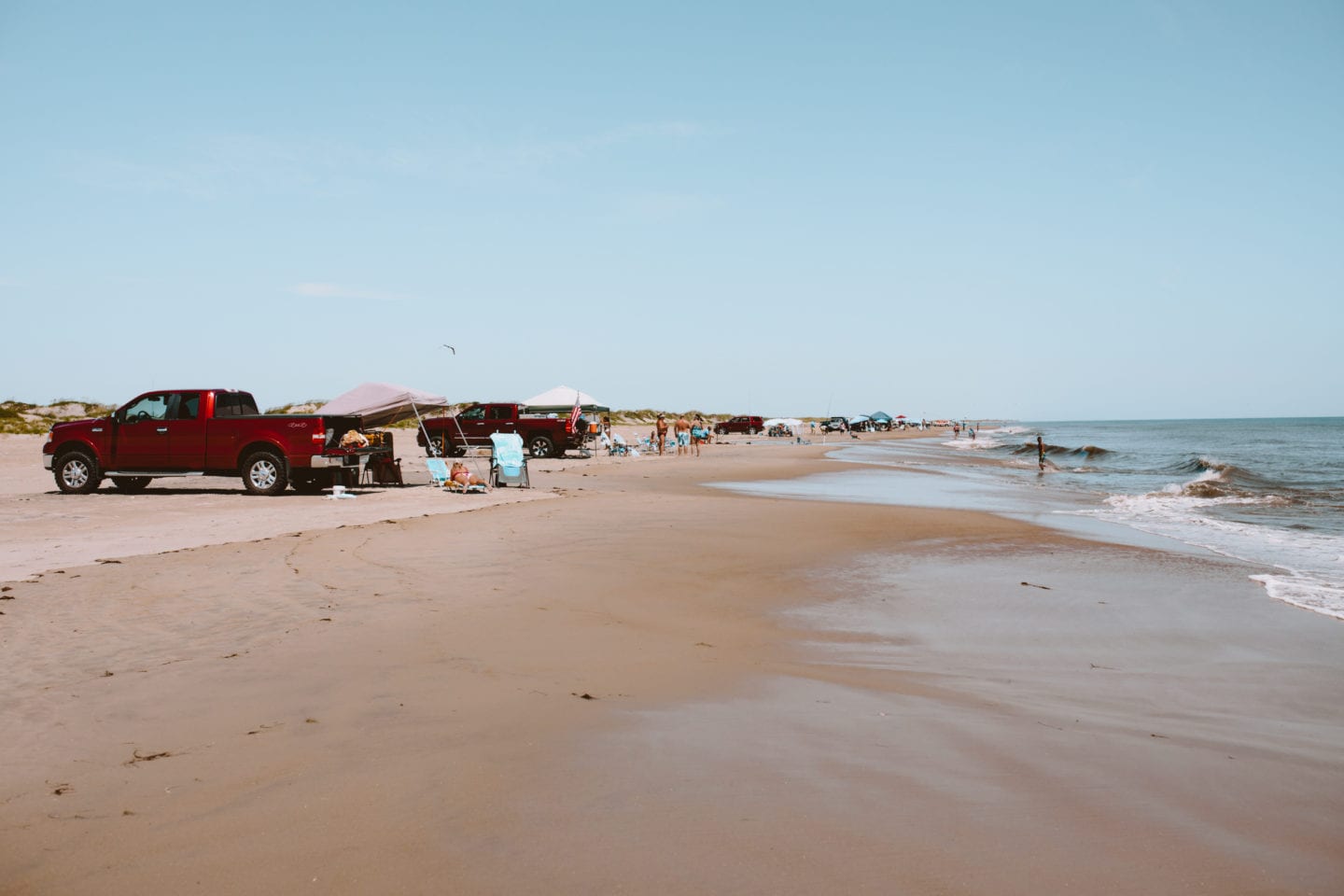Beach with trucks and people fishing, Outer Banks itinerary