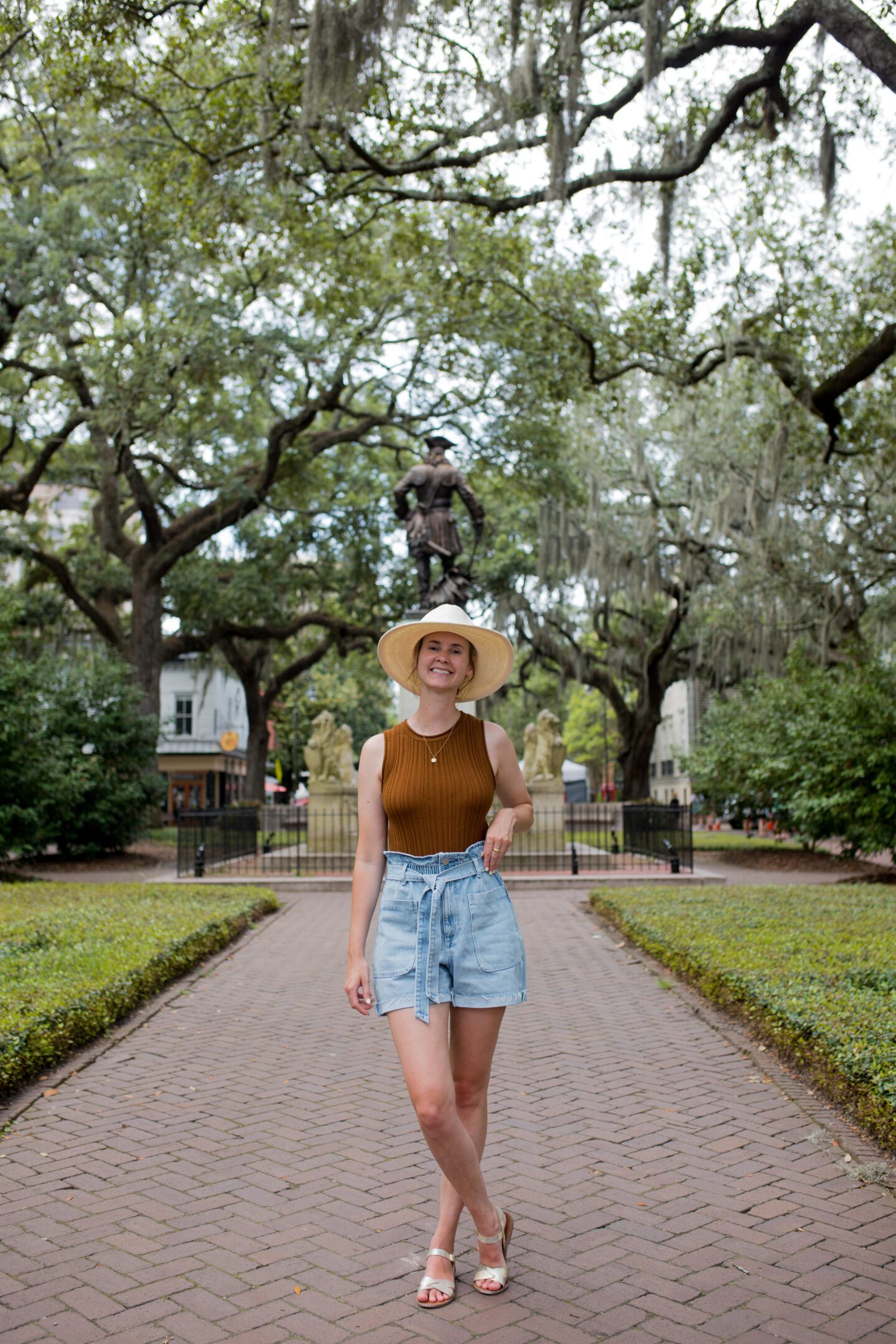 Girl standing in front of a statue, Savannah Georgia