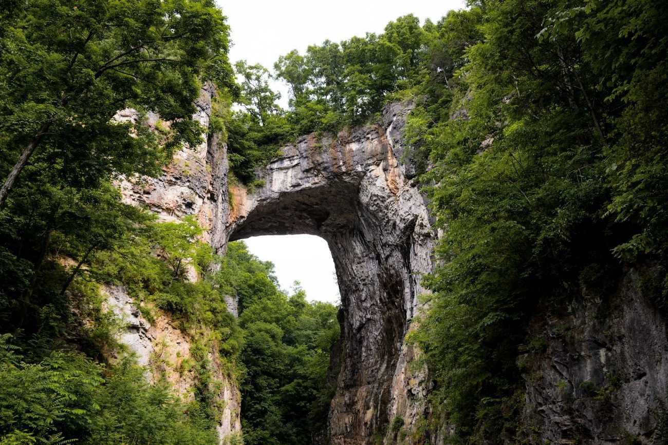 A rock bridge covered in trees, best small towns in Virginia