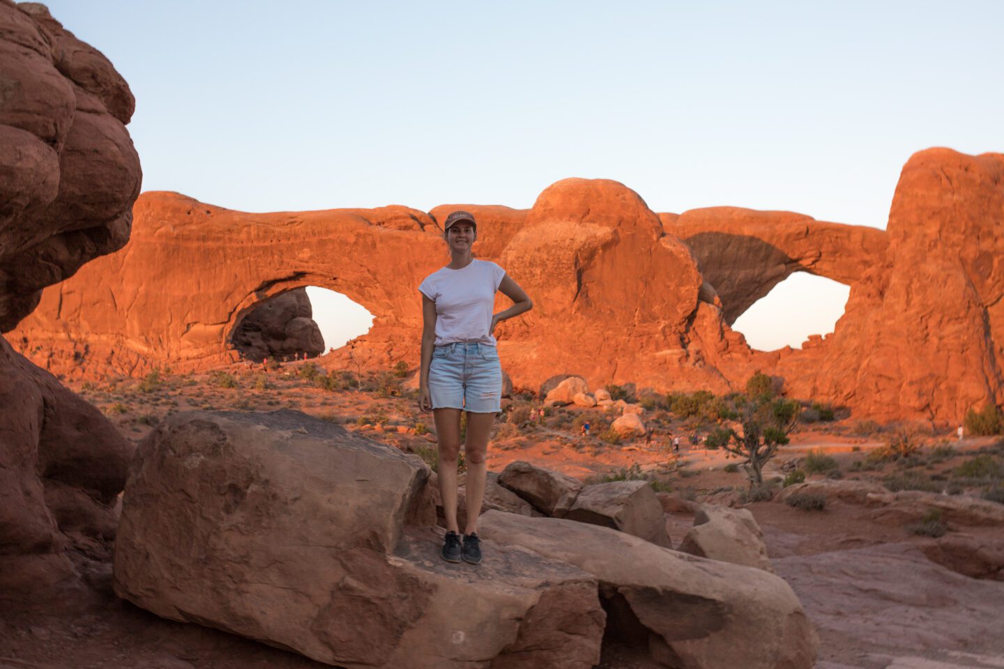 Girl standing in front to two large arches 