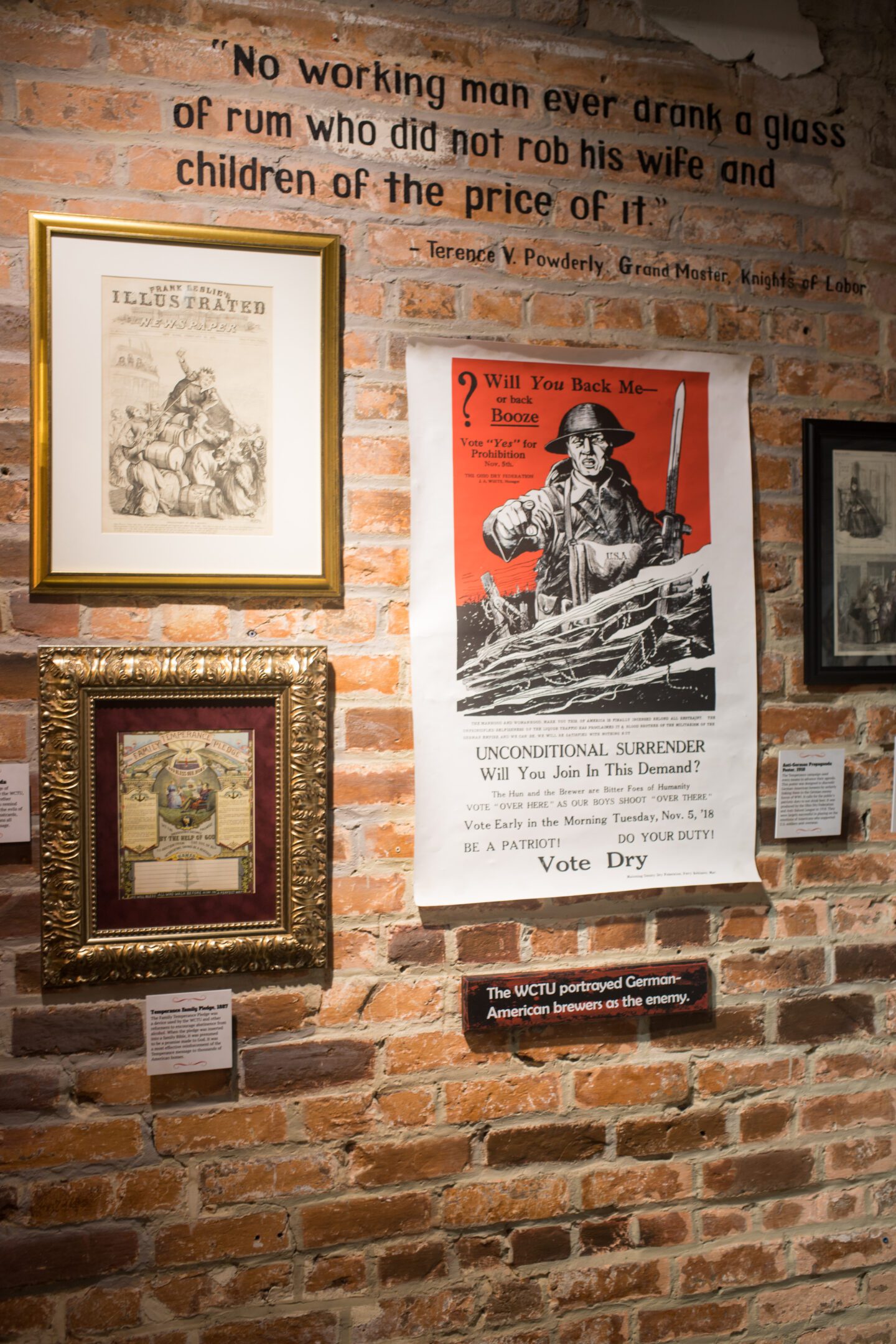 A brick wall with photo frames and posters