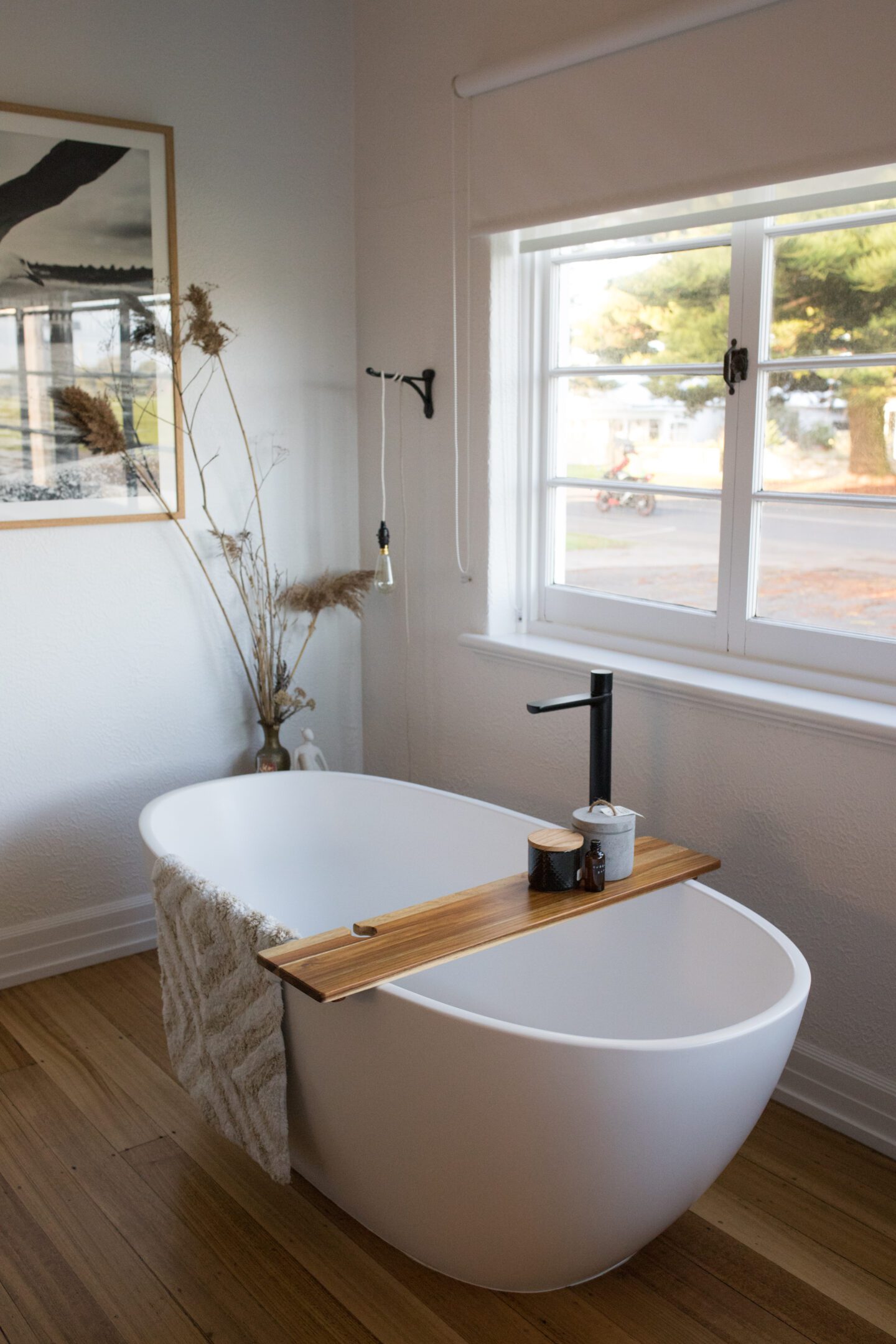 A bathtub underneath a window