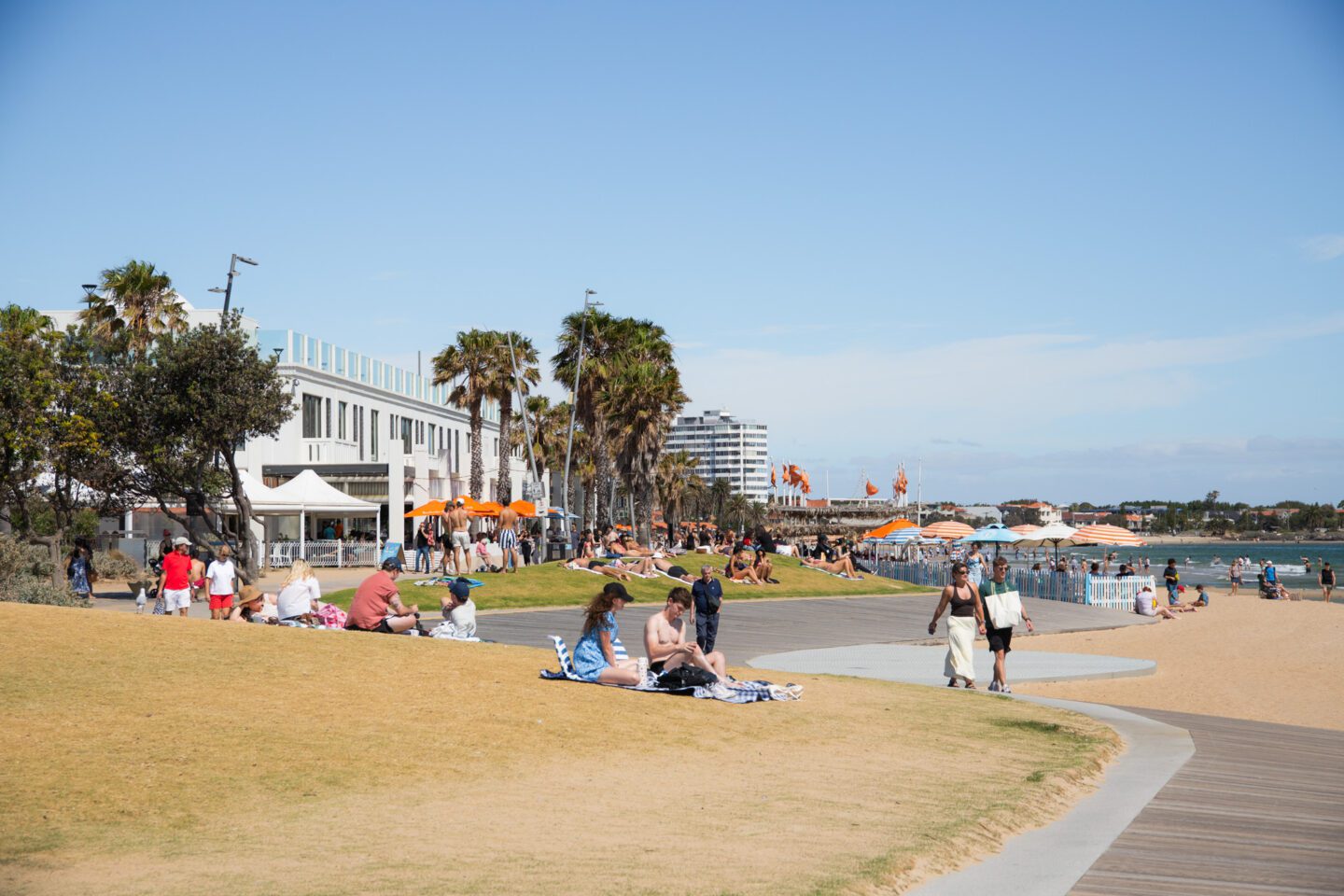 People sunbathing on a beach, things to do in st kilda melbourne