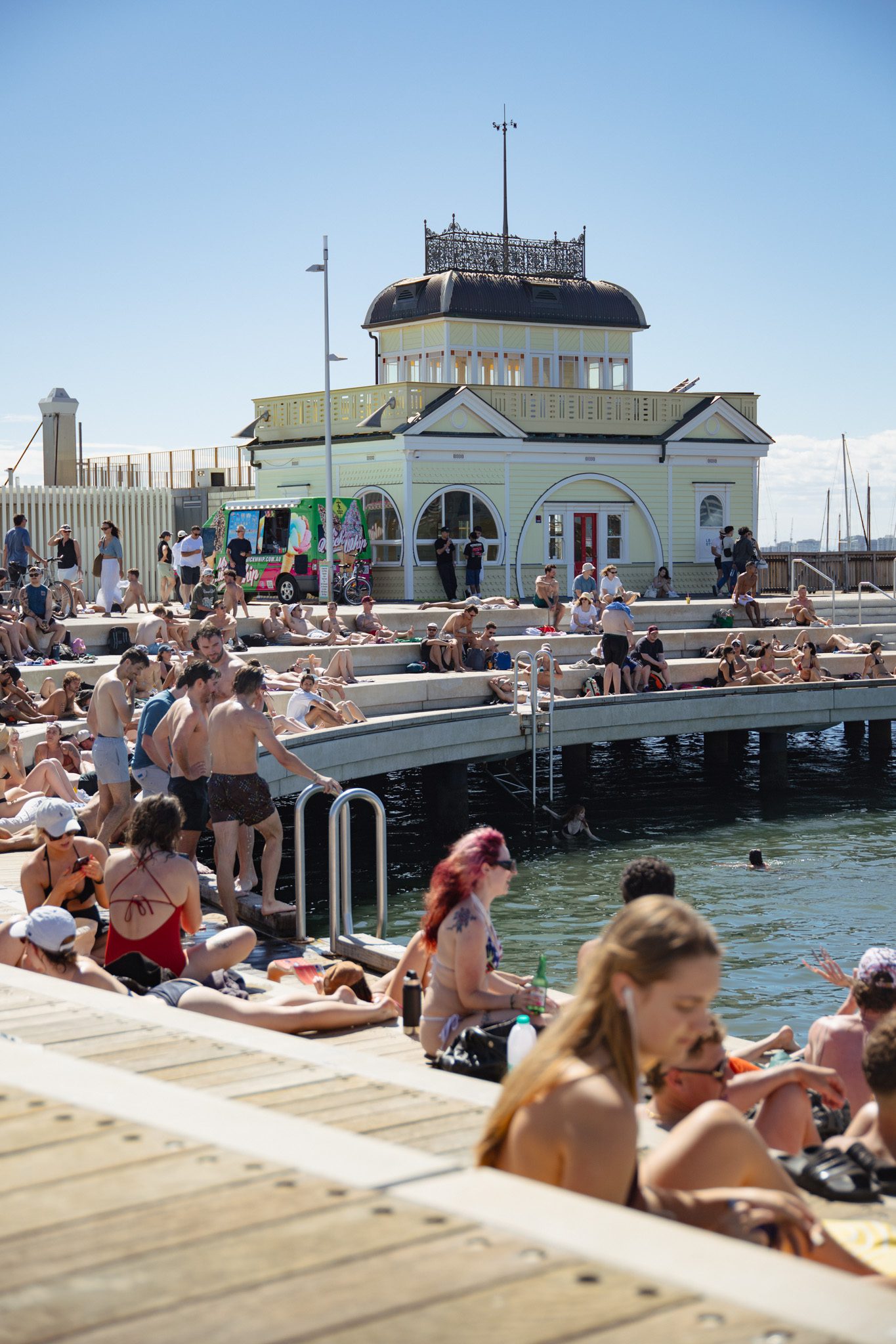 St Kilda Pier with people sunbathing, things to do in st kilda melbourne